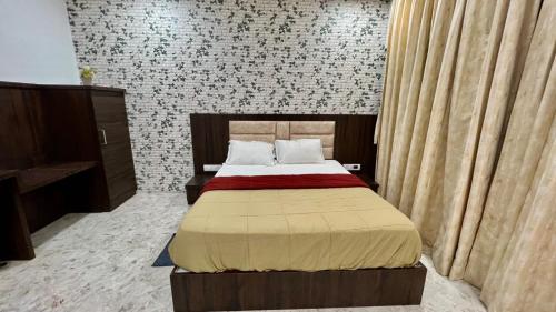 a bedroom with a large bed in a room at Hotel Soubhagya Inn PVT LTD in Silvassa
