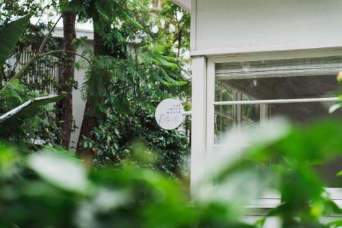 a window of a house with a sign on it at The Cottage at Pearl Beach in Pearl Beach