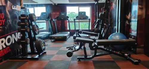 a gym with lots of equipment in a room at Sarovar Portico Kolkata in Kolkata