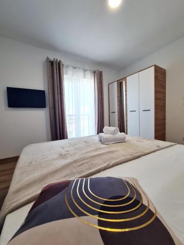 a bedroom with a large bed with a large window at Esther Line Apartments-Near Iulius Mall, Self Check-in,Free Private Parking subject to availability in Timişoara