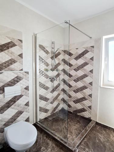 a bathroom with a shower and a toilet at Esther Line Apartments-Near Iulius Mall, Self Check-in,Free Private Parking subject to availability in Timişoara