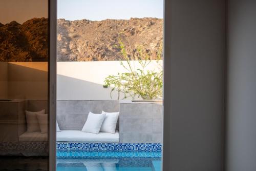 a room with a table with a potted plant on it at The Valley Villas in Sharīyah