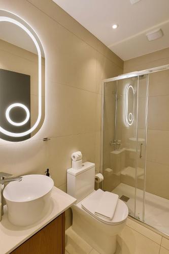 a bathroom with a toilet and a sink and a shower at NÓA Rooms - Adults Only in Ayia Napa
