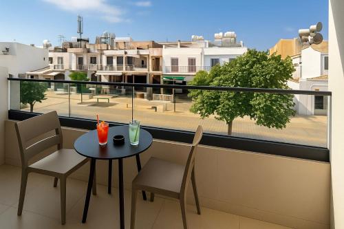 a balcony with a table and chairs and a view of a city at NÓA Rooms - Adults Only in Ayia Napa