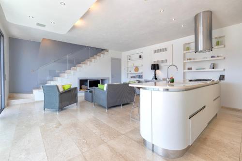 a kitchen and living room with a staircase at Casa Katy Sul Porto Di Stintino in Stintino