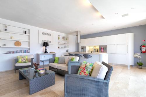 a living room with a couch and chairs and a table at Casa Katy Sul Porto Di Stintino in Stintino