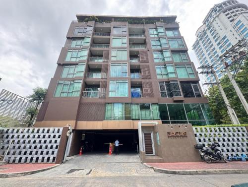 a tall building with a motorcycle parked in front of it at Central Living Ploenchit in Bang Kapi
