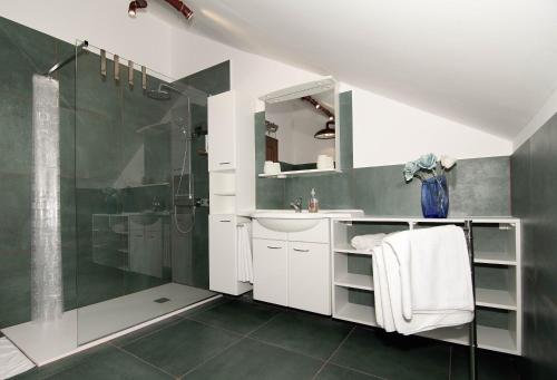 a bathroom with a shower and a sink and a mirror at Grenko House in Vrata