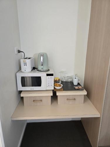 a kitchen with a counter with a microwave on it at KooWeeRup Motel in Koo-Wee-Rup