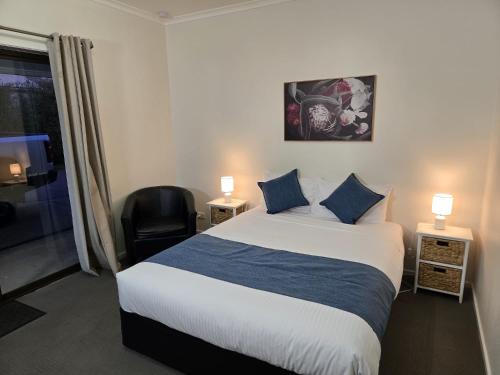 a hotel room with a bed and a chair at KooWeeRup Motel in Koo-Wee-Rup