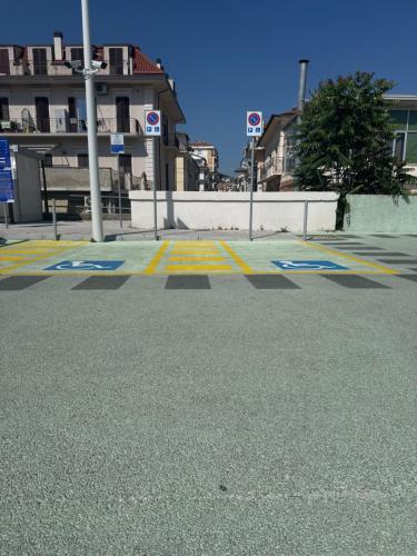 an empty street with a parking lot with buildings at Virginia Madre Luxury Rooms in San Benedetto del Tronto