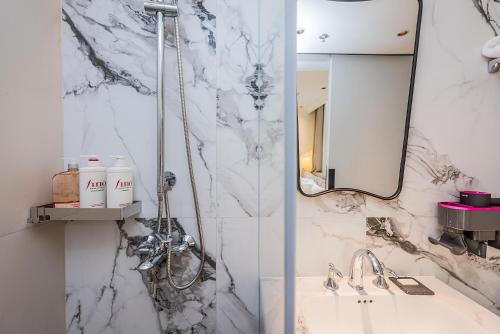 a bathroom with a sink and a mirror at TUIWA Garden Holiday Villa in Qingdao