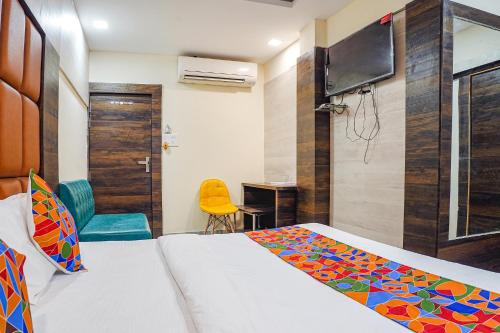 a bedroom with a bed and a desk and a television at FabHotel Brij Residency - hoshangabad , Near barkatullah university in Naiāpura