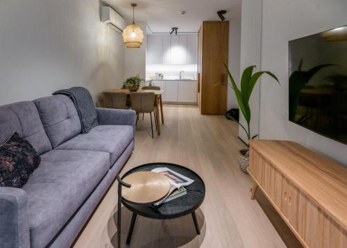 a living room with a couch and a table at Apartamenty na Półwyspie Wydma&Las in Jastarnia
