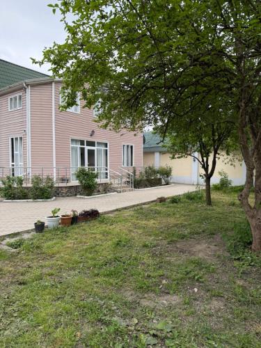 a house with a tree in a yard at Riverside House Quba in Quba