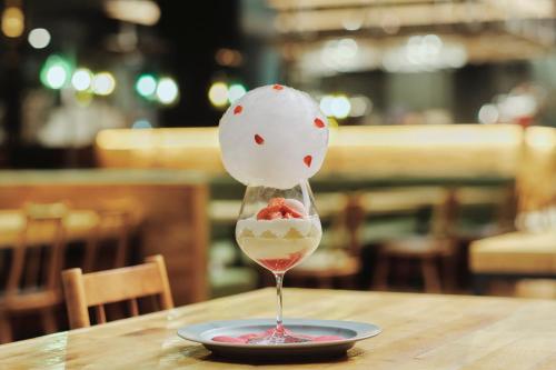 a dessert in a wine glass on a table at OMO7 Asahikawa by Hoshino Resorts in Asahikawa