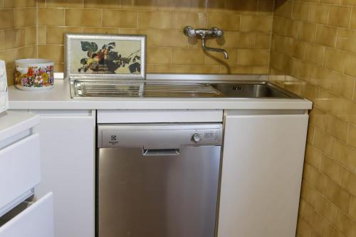 a kitchen with a sink and a dishwasher at Perlablu' Home in Anzio