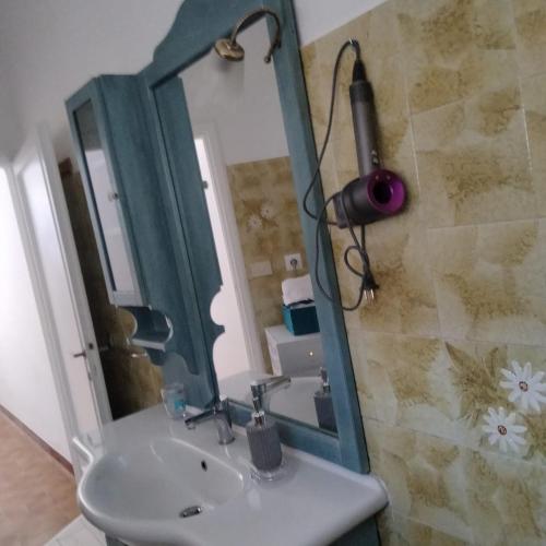 a bathroom with a sink and a mirror at Perlablu' Home in Anzio