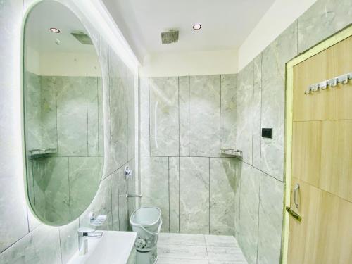 a bathroom with a shower and a sink and a mirror at Hotel Innova By Bedrock Hospitality in Amritsar