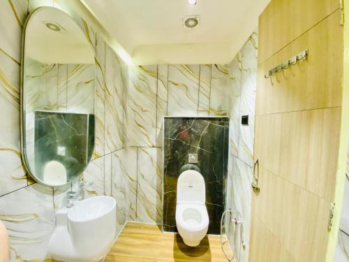 a bathroom with a toilet and a sink and a mirror at Hotel Innova By Bedrock Hospitality in Amritsar