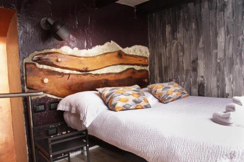 a bedroom with a bed with a wooden headboard at Urban Loft 56 Moscova- Metro 2 min - TheModelsApartment in Milan
