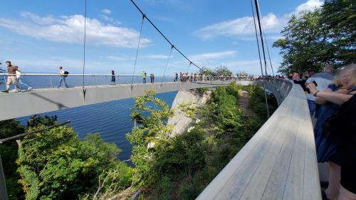 people walking on a bridge over a river at prora46 Meerblick Apartment in Binz