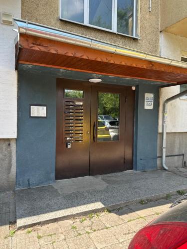 a brown door of a building with a parking lot at Апартамент Миели in Sofia