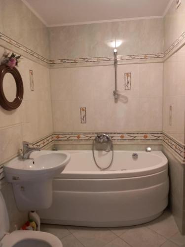 a bathroom with a tub and a sink and a toilet at Widoczek in Polańczyk