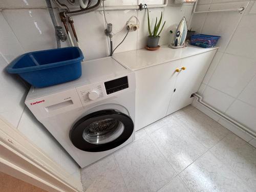 a laundry room with a washing machine in a bathroom at Penthouse w/ sea view, pool & beach in Calafell