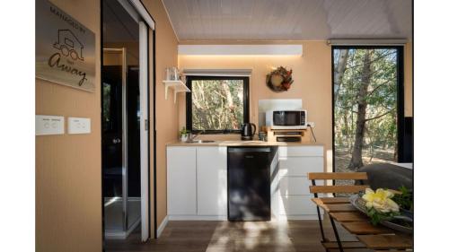a kitchen with a sink and a counter top at Manna Gum Retreat by Tiny Away in Allansford