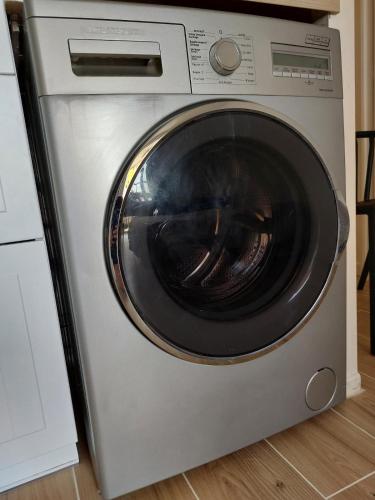 a silver washing machine sitting in a kitchen at Appart avec loggia en front de mer et superbe vue in Le Barcarès