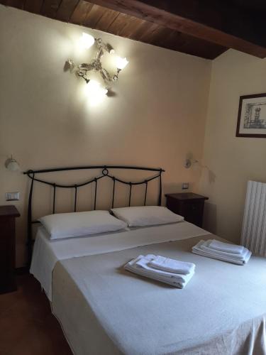 a bedroom with a bed with two towels on it at La Costa Del Sole in San Fele