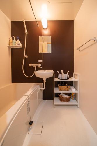 a bathroom with a sink and a mirror at 夏様五条丹波口 Modern Kyoto Townhouse, Whole House in Kyoto