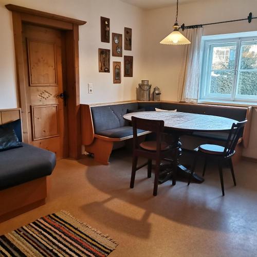 a living room with a table and chairs and a couch at Bodenschmiede in Hopfgarten im Brixental