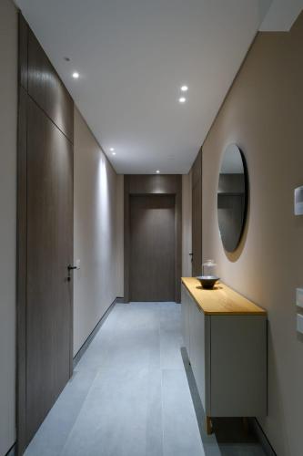 a hallway with a wooden counter and a mirror at The Red Residence North Coast Egypt in Mājid Abū Zayd