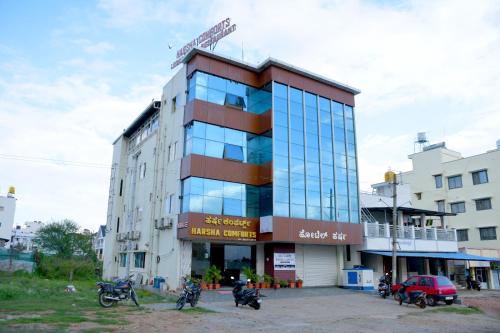 a building with motorcycles parked in front of it at Harsha Comforts in Chikmagalūr