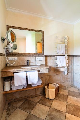 a bathroom with a sink and a mirror at Hotel garni Fischerweber am See in Rottach-Egern
