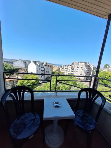 a table and two chairs in front of a window at Hotel Elica in Varna City