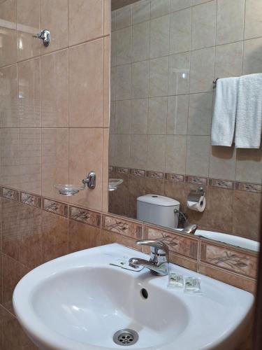 a bathroom with a white sink and a mirror at Hotel Elica in Varna City