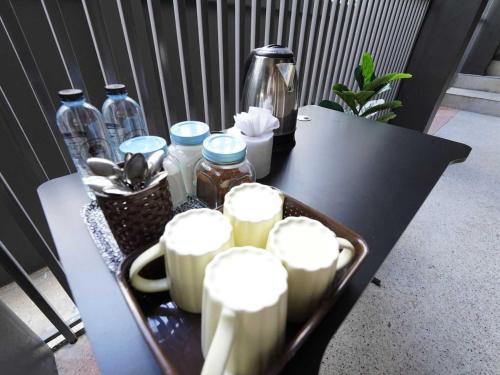 a black table with a tray of drinks on it at Dancenter Rq Bangkok Huai Khwang in Bangkok