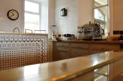 a kitchen with a counter and a clock on the wall at The Park in Peebles