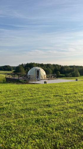 a large tent in the middle of a field at Saules sēta in Tīnūži