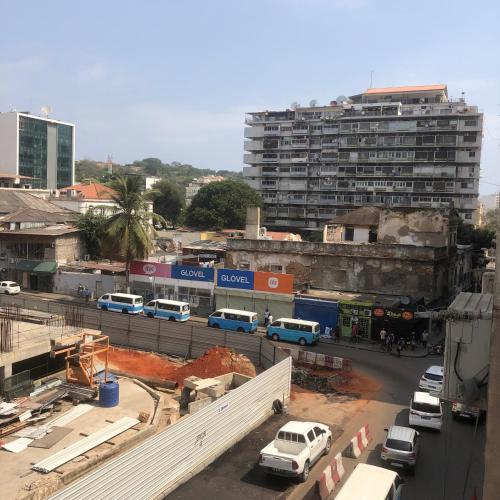 a city with cars parked on a street with a building at Mutamba Prime Stay in Luanda
