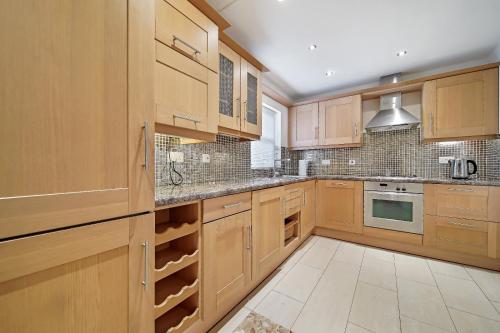 a large kitchen with wooden cabinets and appliances at 29 Fintra Bay with direct access to the beach in Saint Catherines
