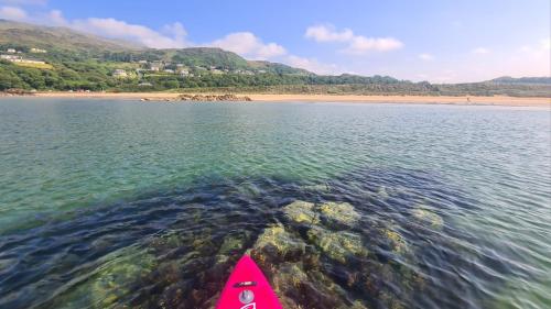 a kayak in the water next to a beach at 29 Fintra Bay with direct access to the beach in Saint Catherines