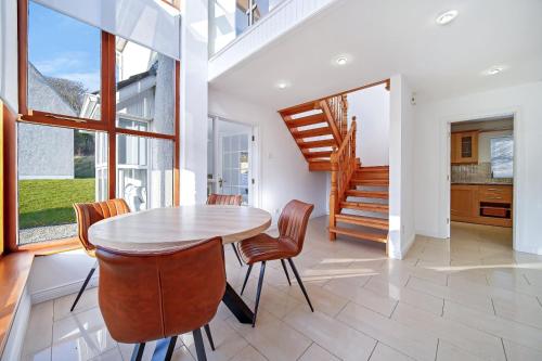 a kitchen and dining room with a table and chairs at 29 Fintra Bay with direct access to the beach in Saint Catherines