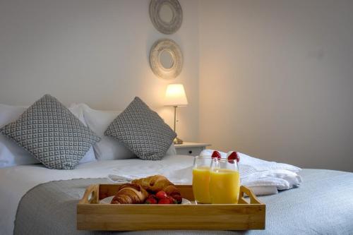 a tray of food and drinks on a bed at Walton by Holmesdale Homes in Milton Keynes