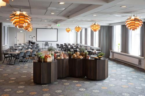 a conference room with tables with food on them at Scandic Regina in Herning