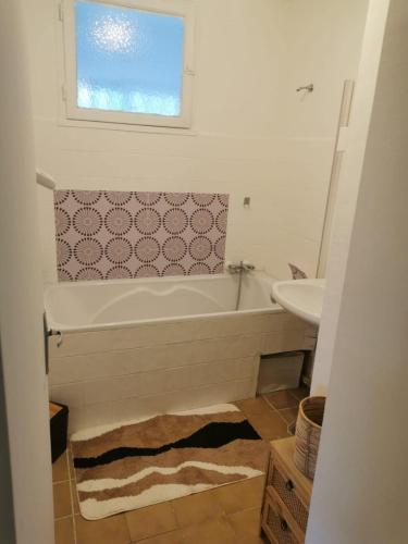 une salle de bain avec une baignoire et un lavabo dans l'établissement appartement 2 chambres, à Draguignan