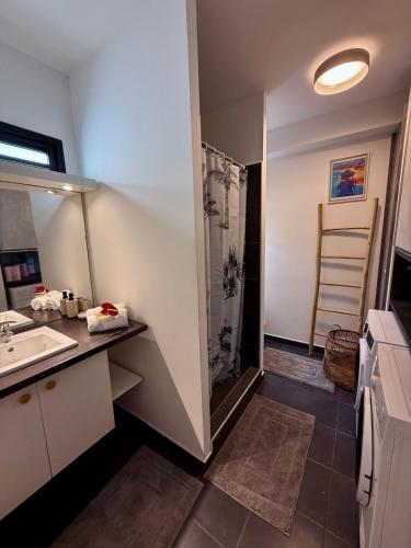 a bathroom with a sink and a shower at Otemanu Lagoon Apartment with Lagoon View in Bora Bora